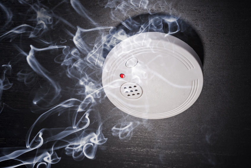 27738215 - smoke detector in the smoke of a fire